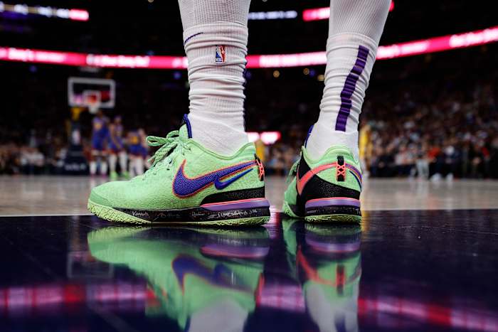 View of LeBron James' green and blue Nike shoes.